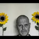 unhappy man with sunflowers
