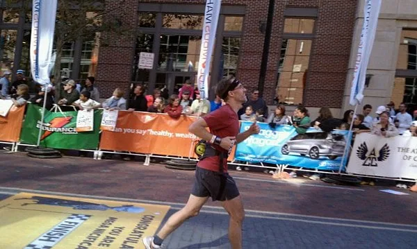 Dave crossing marathon finish line