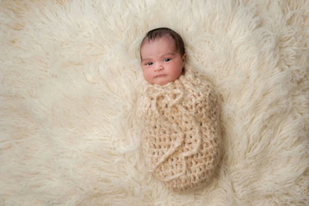 infant bundled in pouch